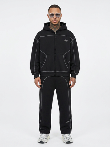 PYRO Boxy Zip Hoodie – Model trägt schwarzen Tracksuit mit Kontrastnähten